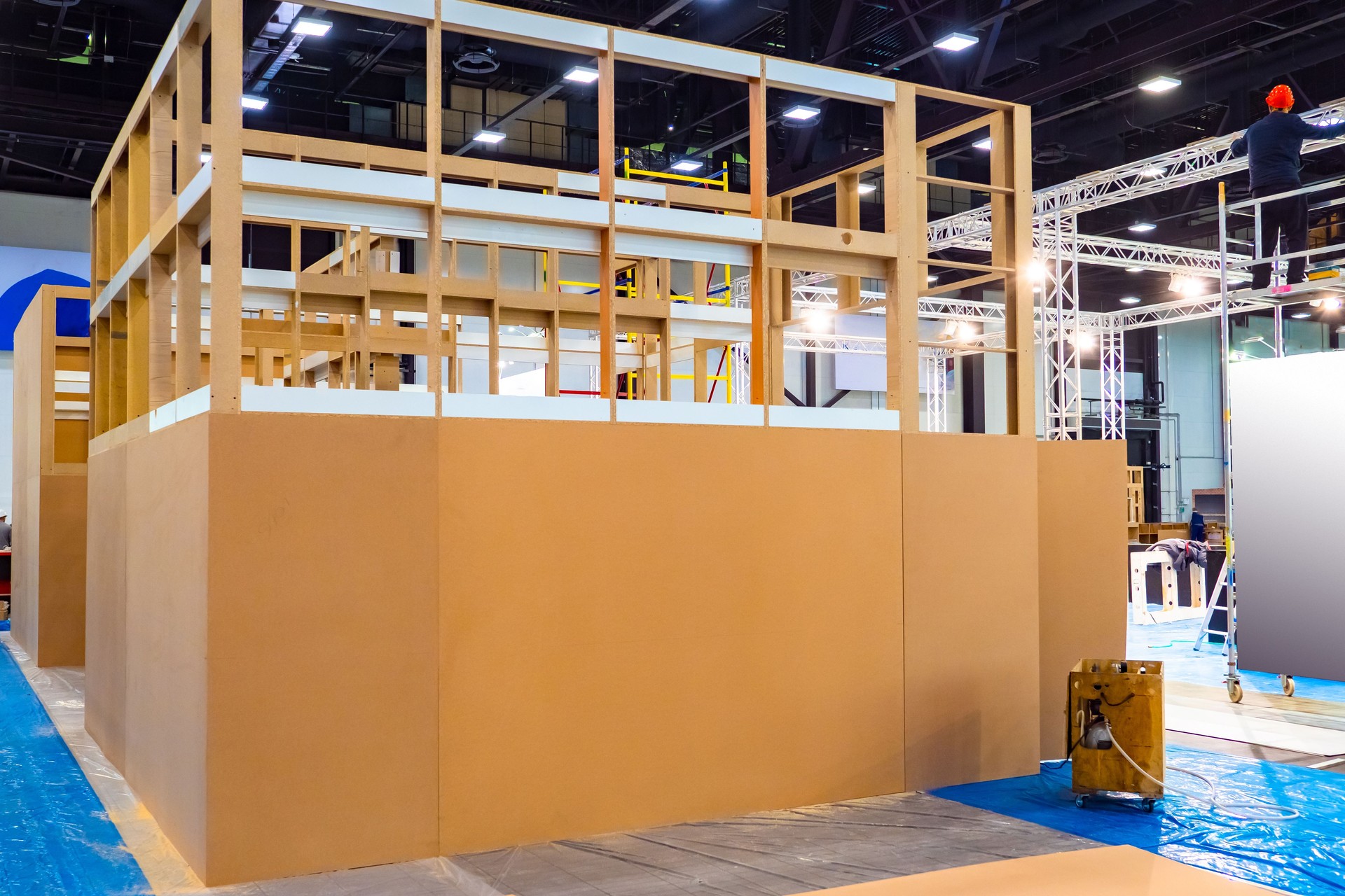 Temporary constructions in the exhibition center. Wooden structures in the exhibition center. Concept - preparation of the exhibition. Rental of metal and wooden structures. Work in the show center